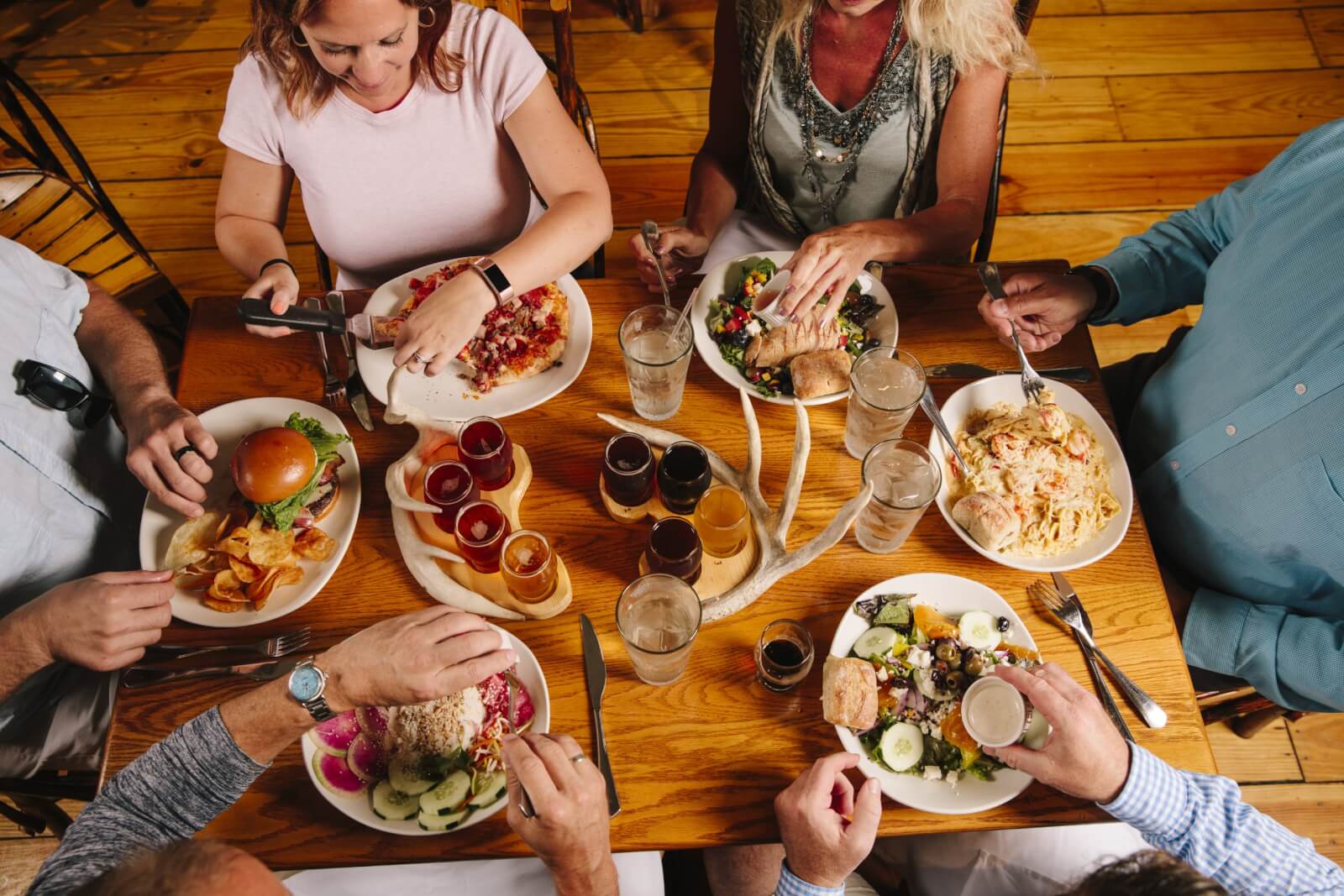 Group of men and women dining together.